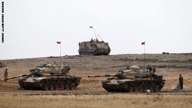 SANLIURFA, TURKEY - OCTOBER 11: Turkish army tanks take position on top of a hill near Mursitpinar border crossing in the southeastern Turkish town of Suruc in Sanliurfa province October 11, 2014. Kurdish forces have called for more U.S-led airstrikes against Islamic State in Kobani and for Turkey to open its borders to allow military supplies to get through to the Kurdish forces in the besieged Syrian town. (Photo by Gokhan Sahin/Getty Images)