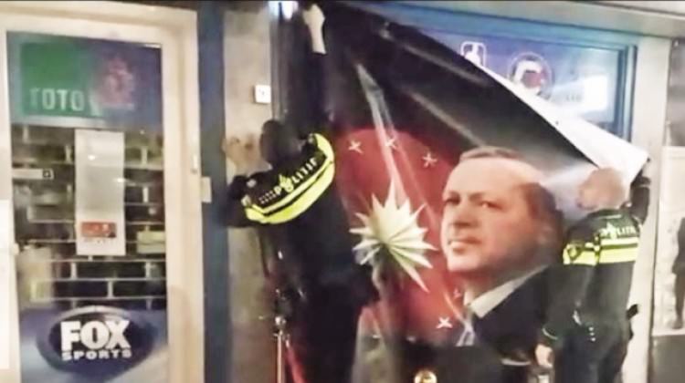 الشرطة الهولندية تنزل صورة أردوغان من واجهة محل تجاري لمغترب تركي
