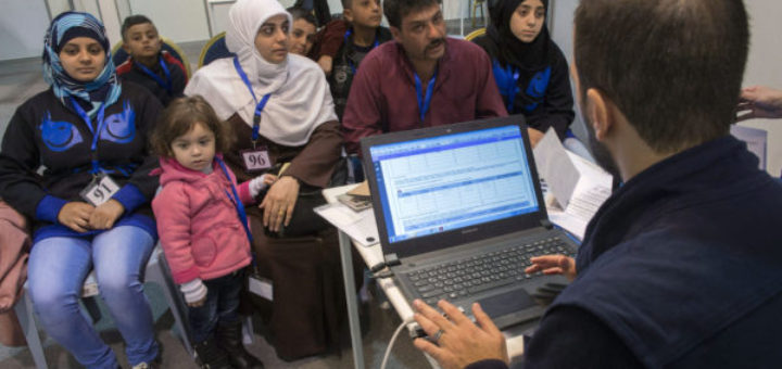 A family of Syrian refugees are interviewed by authorities in hope of being approved for passage to Canada at a refugee processing center in Amman, Jordan, Sunday, Nov. 29, 2015. A trickle of Syrian refugees seeking to leave Jordan flowed into Canada's processing centre in Amman on Sunday, the first day of operations at what will eventually become the hub of much of the Syrian refugee resettlement program, according to The Canadian Press. (Paul Chiasson/The Canadian Press via AP) MANDATORY CREDIT