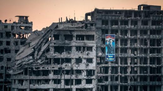 صورة بشار الأسد على الدمار في سوريا