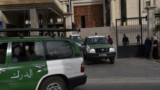 A police convoy accompanying the ambulance which brought on February 4, 2021 Abdelmalek Hamzaoui(not seen) -- one of the alleged jihadists accused of murdering Herve Gourdel -- leaves the Algerian Dar Al-Baida Tribunal in the capital Algiers, after the postponement of the court hearing in the case of the French mountain guide who was decapitated almost six years ago in Algeria. - Fourteen people are being prosecuted: 8 suspected kidnappers, the 5 Algerian hosts and companions of the Frenchman, as well as a man, Farjallah Amara, whose link to this case is not specified, according to a court document consulted by AFP. Gourdel, 55, was abducted on September 21, 2014 while exploring Djurdjura National Park, a draw for hikers but which has long been a sanctuary for jihadists. (Photo by RYAD KRAMDI / AFP)